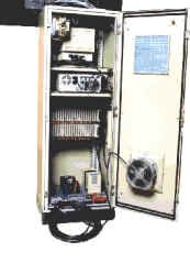 Rear view of CES Model 7 control cabinet showing monitor, computer, and interface card rack